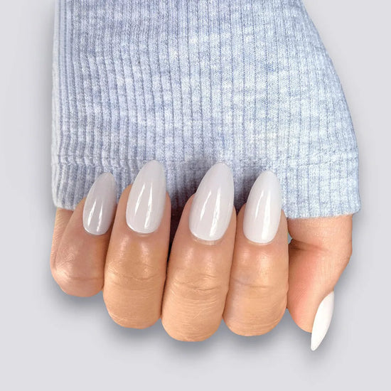 Lady Jane cool-toned grey almond press on nails worn on hand with fingers fanned. de blinkie press on nail set