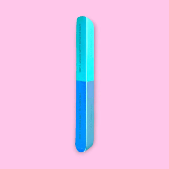 Full length view of de blinkie 7-in-1 nail buffer showing steps 1 and 2 against a pink background
