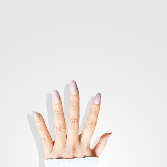 Hand pose showing de blinkie Bare Elegance soft pastel pink nude gloss press-on nails in short oval
