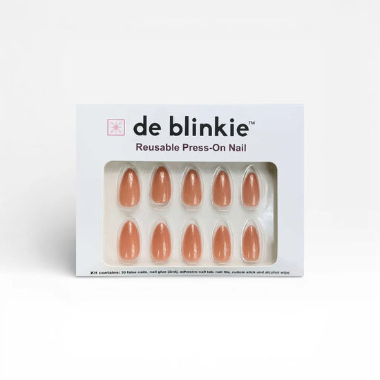 de blinkie Blush Apricot reusable press-on nail kit box showing 10 short almond false nails with warm peachy nude pearlescent finish on white tray against white background