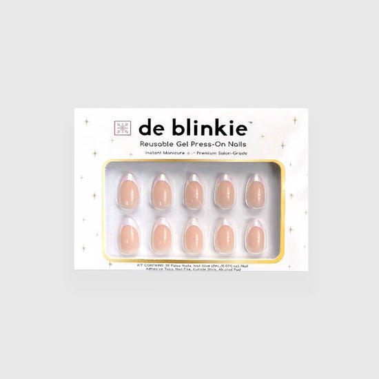 Box shot of de blinkie Blush Mirage reusable gel press-on nails in warm nude and aurora iridescent French tip short almond against a light grey background