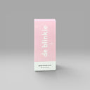 Front of de blinkie Brush-On Nail Glue 7g box in pink and white against a grey background