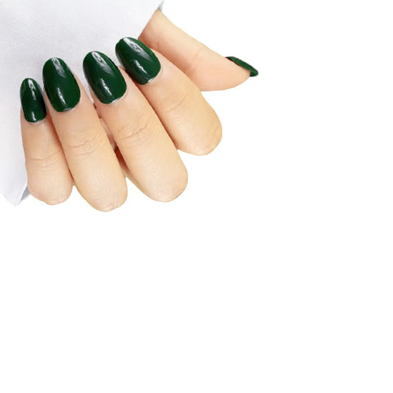 Claw pose showing de blinkie Emerald Envy deep jewel-toned forest green press-on nails in short oval shape against white background with white fabric sleeve