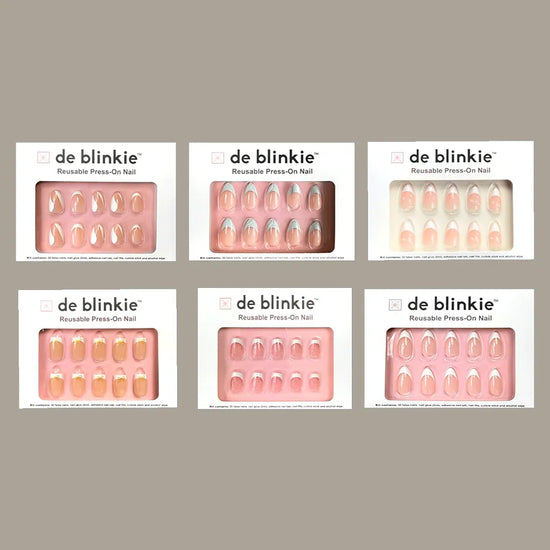 Box shot showing all six de blinkie Glass French Revival French tip press-on nail styles against oat background