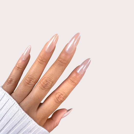 Upright spread hand showing de blinkie Glazed Hazel rosy taupe nude pearl chrome glazed donut medium almond press-on nails against cream background