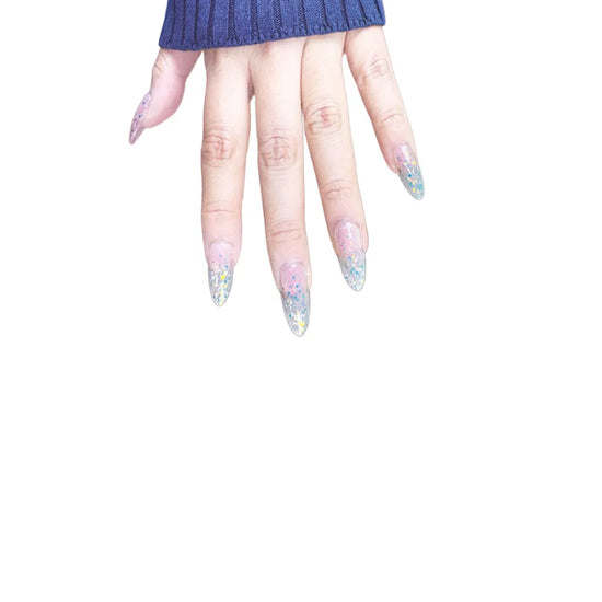 Downward fingers pose showing de blinkie Glitter Drip sheer pink nude base with chunky multicolour glitter press-on nails in medium almond against a clean white background with a dark navy ribbed knit sleeve