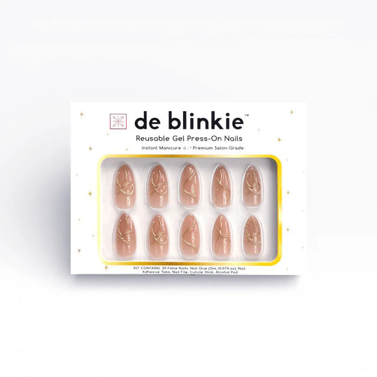 Product box shot showing de blinkie Golden Trace golden nude with 3D gold swirl detail medium almond press-on nails against white background