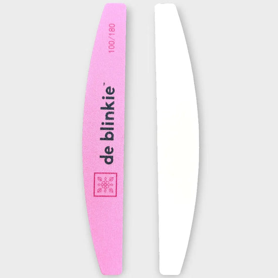 Both sides of de blinkie premium half-moon nail file showing pink 180 grit and white 100 grit sides against a grey background