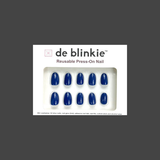 de blinkie Indigo Ivy reusable press-on nail kit box showing 10 short oval false nails with rich indigo blue finish on white tray against dark grey background