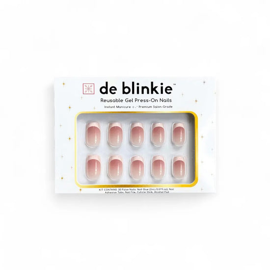 Product box shot of de blinkie Madame Grace sheer pink white French tip reusable gel press-on nails in short square displayed in white branded packaging on a white background with gold star detailing