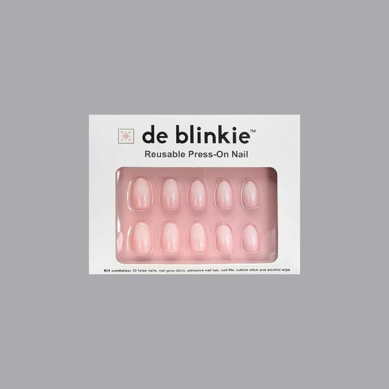 de blinkie Milky Kiss reusable press-on nail kit box showing 10 short oval false nails with soft milky pink finish on pink tray against grey background