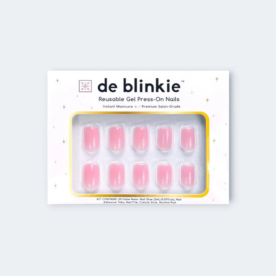 Product box shot of de blinkie Miss Bubbleglam soft bubblegum pink reusable gel press-on nails in short square displayed in white branded packaging with gold star detailing against a soft blue-grey background