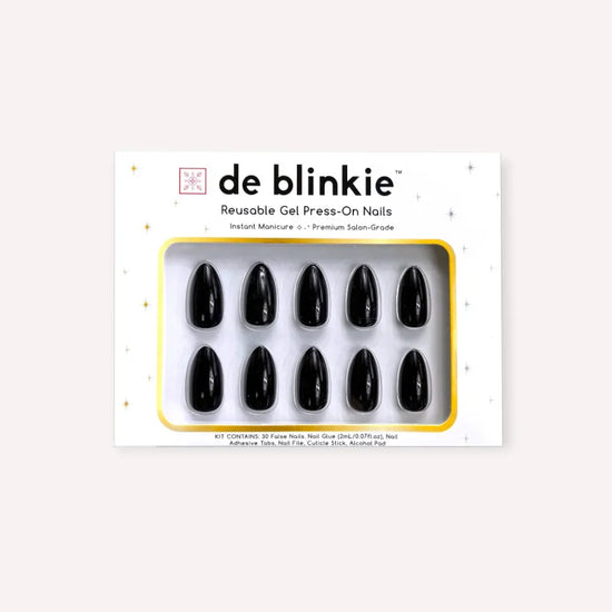 Alternate box shot of de blinkie Miss Noir reusable gel press-on nails in onyx gloss black short almond against a warm white background