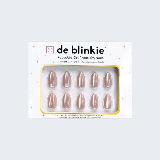 Product box shot of de blinkie Miss Opaline velvet champagne nude reusable gel press-on nails in short almond displayed in white branded packaging with gold star detailing against a soft blue-grey background