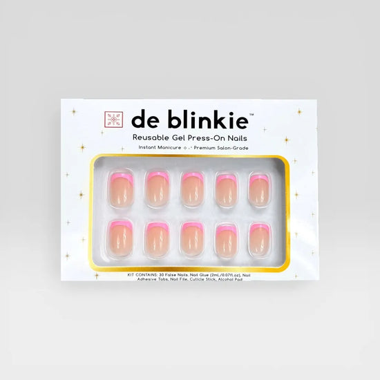 Product box shot of de blinkie Pink Pop Frenchie sheer nude base with soft bubblegum pink French tip reusable gel press-on nails in extra short square displayed in white branded packaging with gold star detailing against a soft grey background