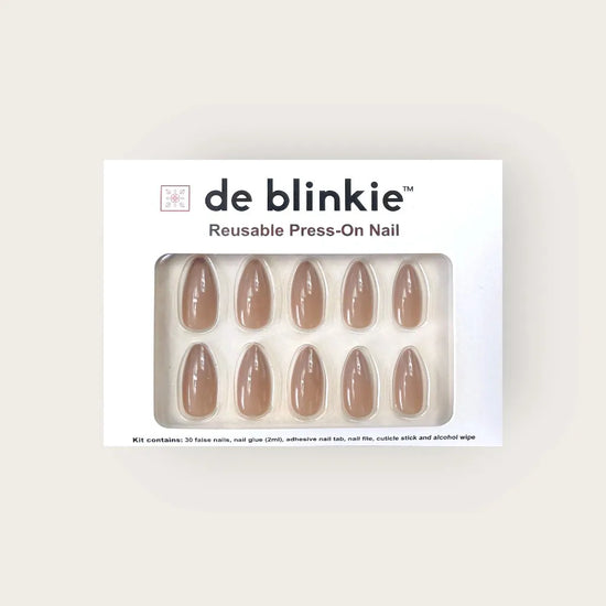 Product box shot of de blinkie Silken Mocha warm taupe nude reusable press-on nails in medium almond displayed in white branded packaging against a warm cream background