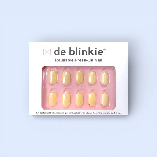 de blinkie Vanilla Crème press-on nail kit box showing 10 short square false nails in butter yellow cream finish on pink tray