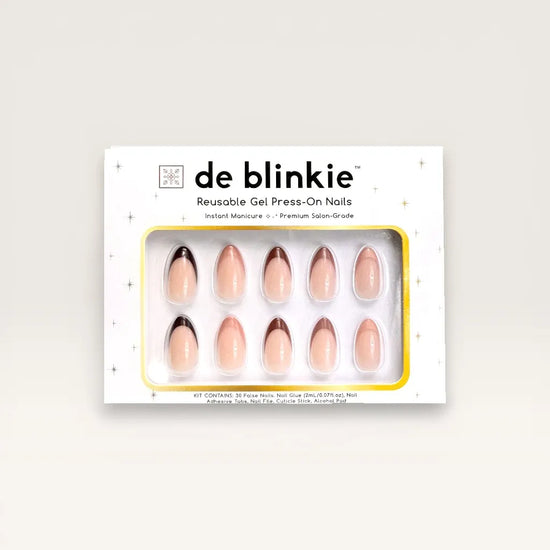 Product box shot of de blinkie Velvet Vixen sheer blush press-on nails with alternating caramel, chocolate and black French tips in short almond displayed in white branded packaging with gold star detailing against a soft cream background